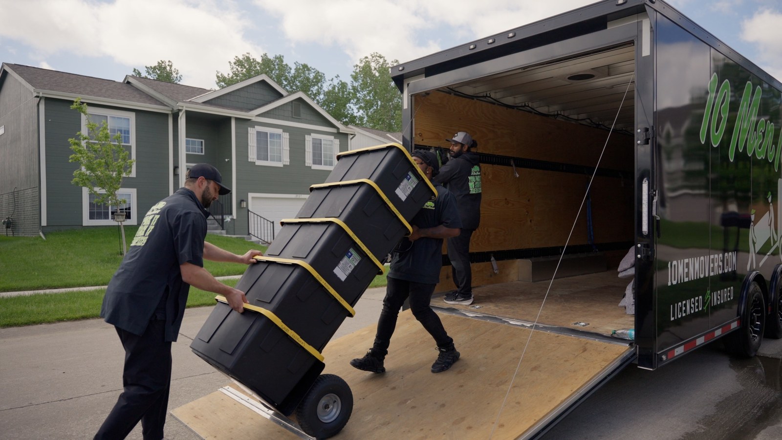 10 Men Movers crew loading boxes into a moving truck in Omaha