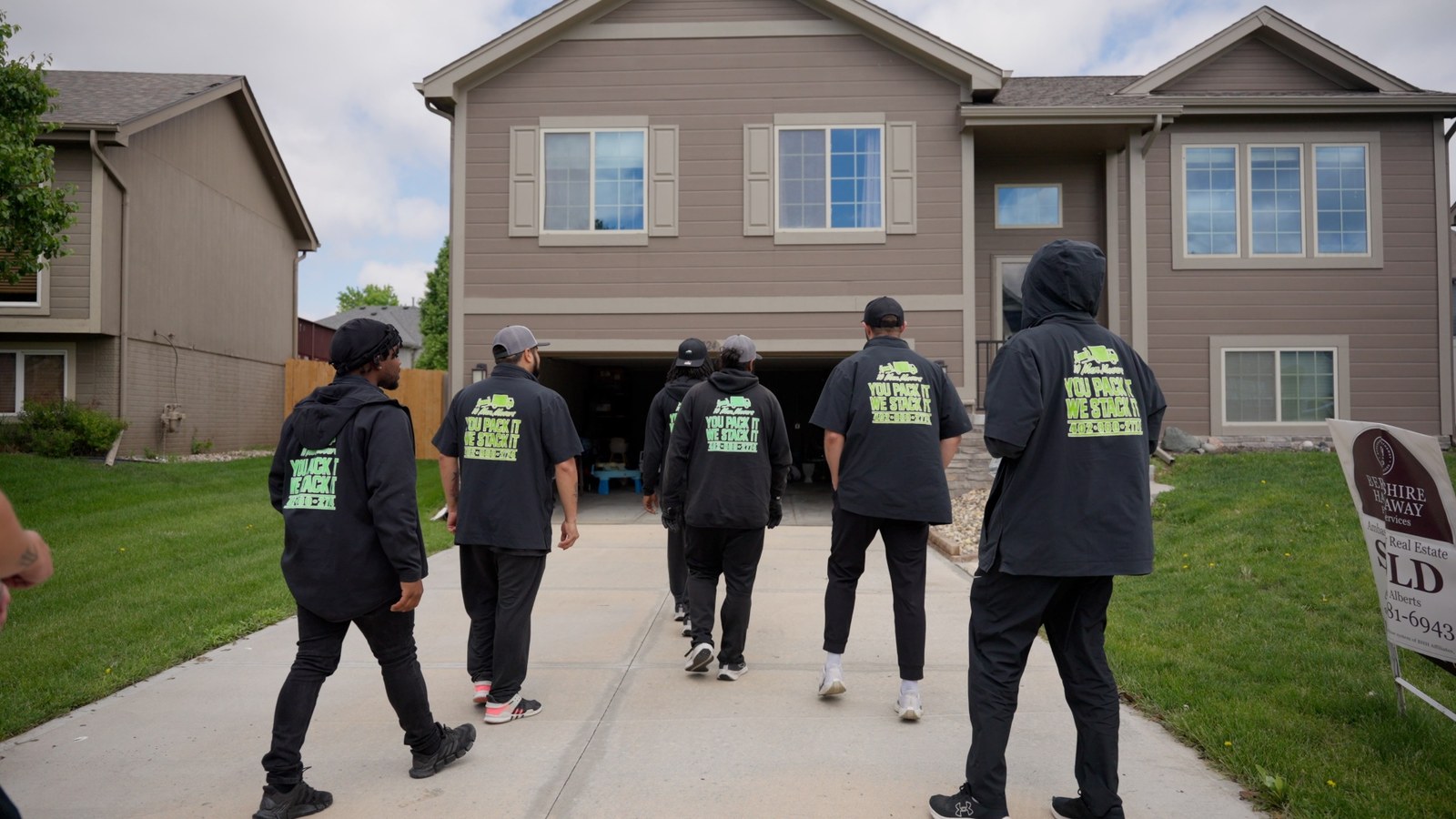 10 Men Movers crew walking up to a customer's Omaha home
