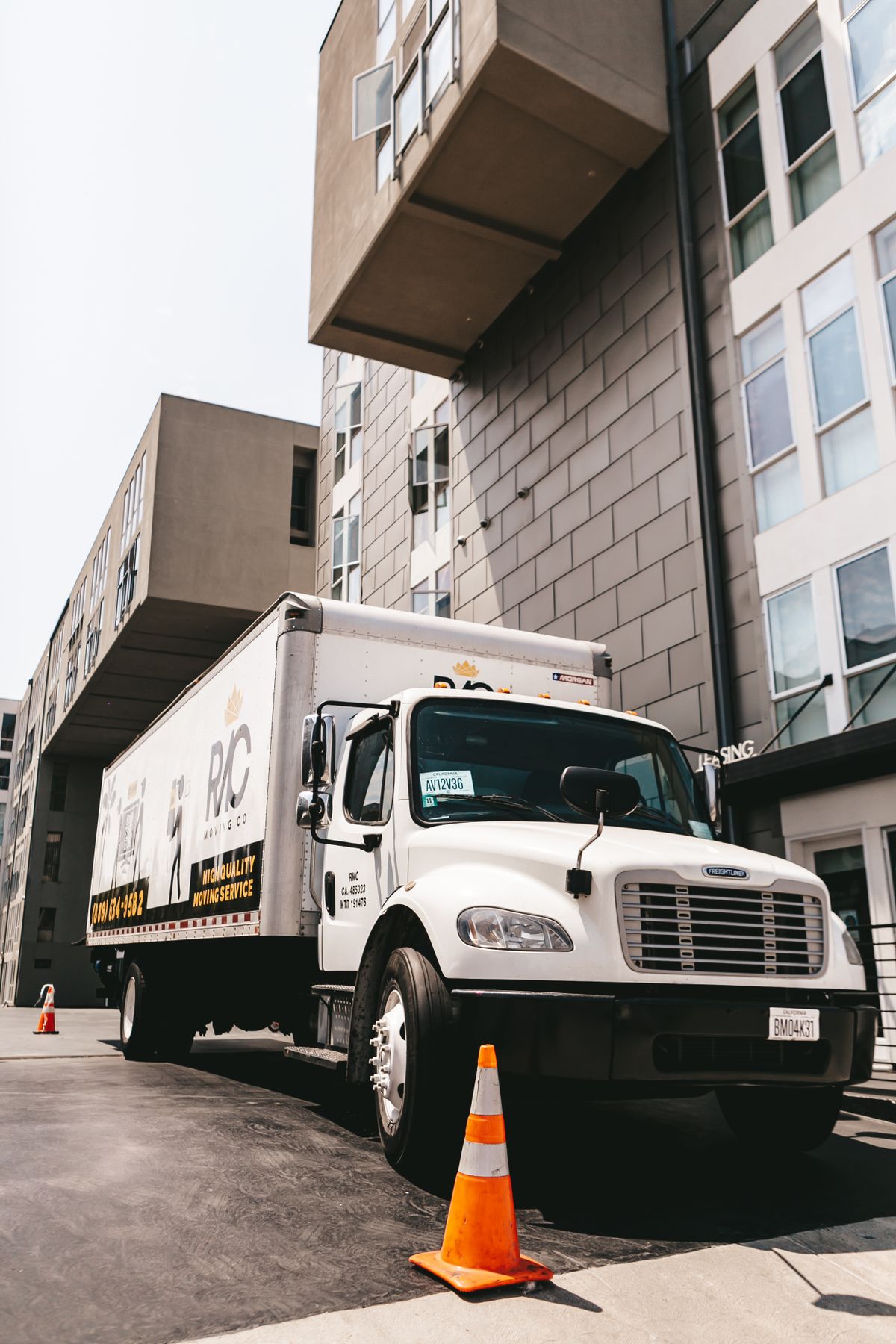 A moving truck parked outside an apartment building