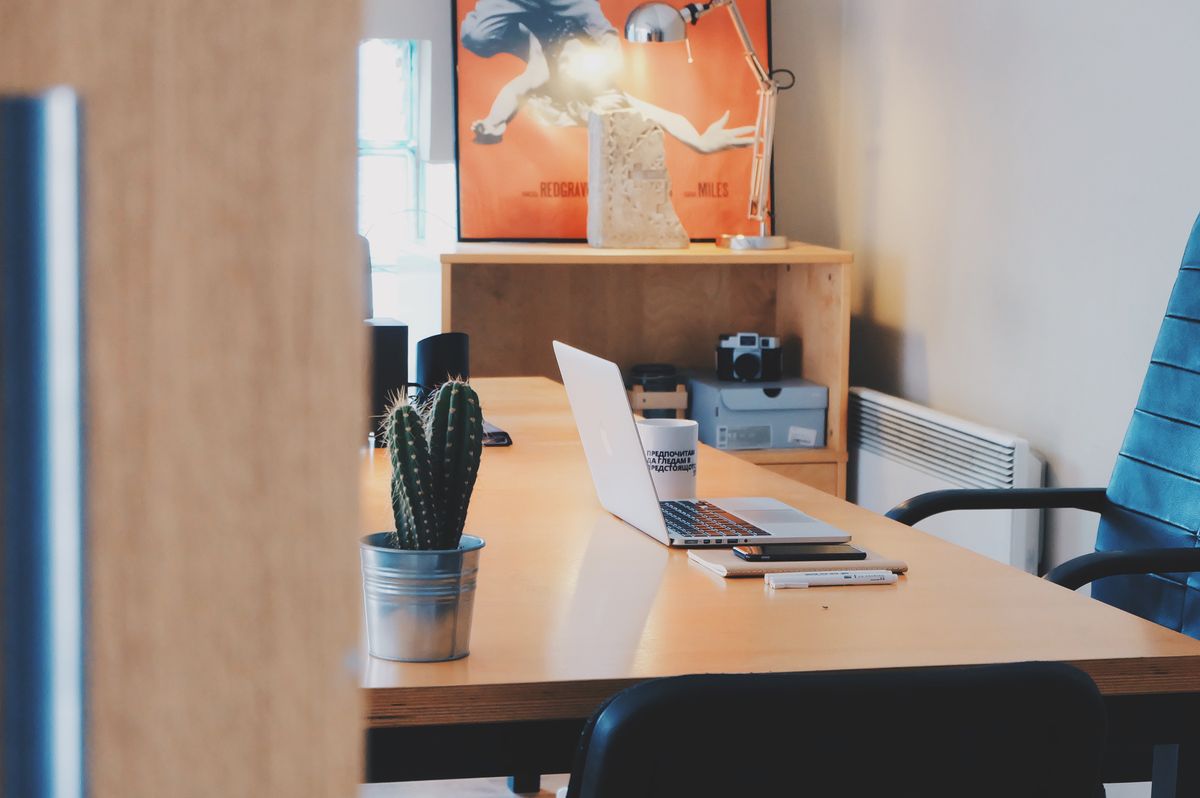 An office desk with a laptop ready for relocation
